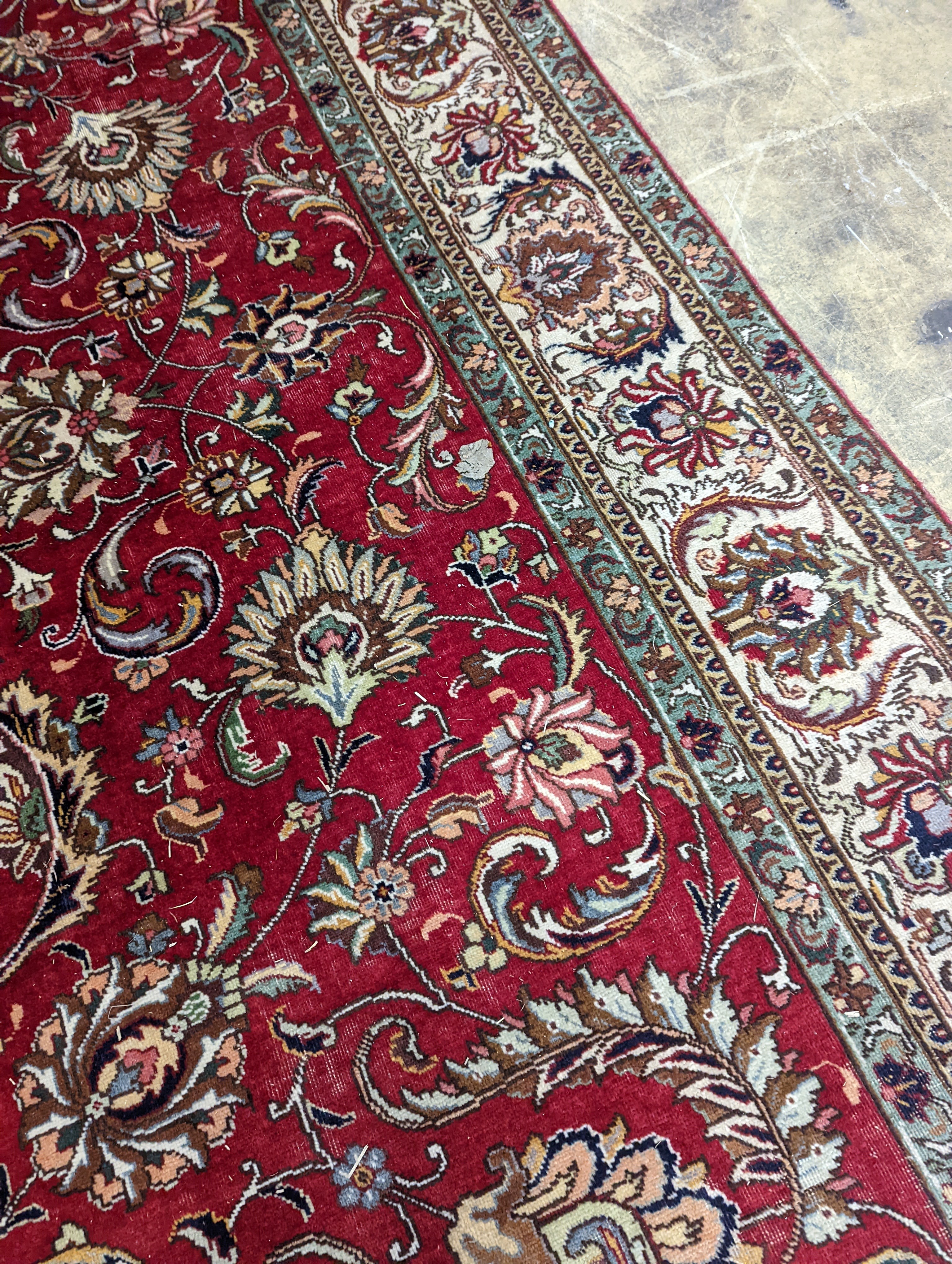 A Tabriz red ground carpet, 400 x 290cm